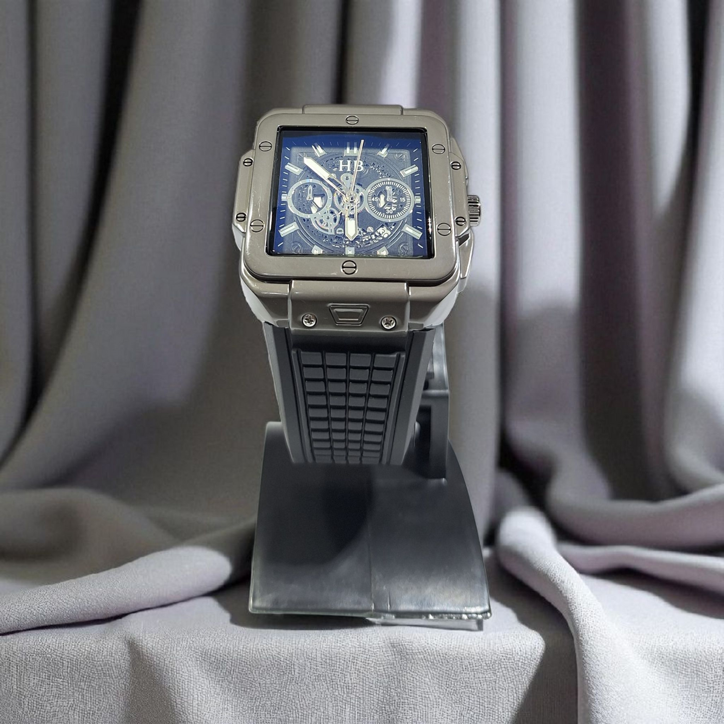 Luxury watch on a stand with a gray curtain background