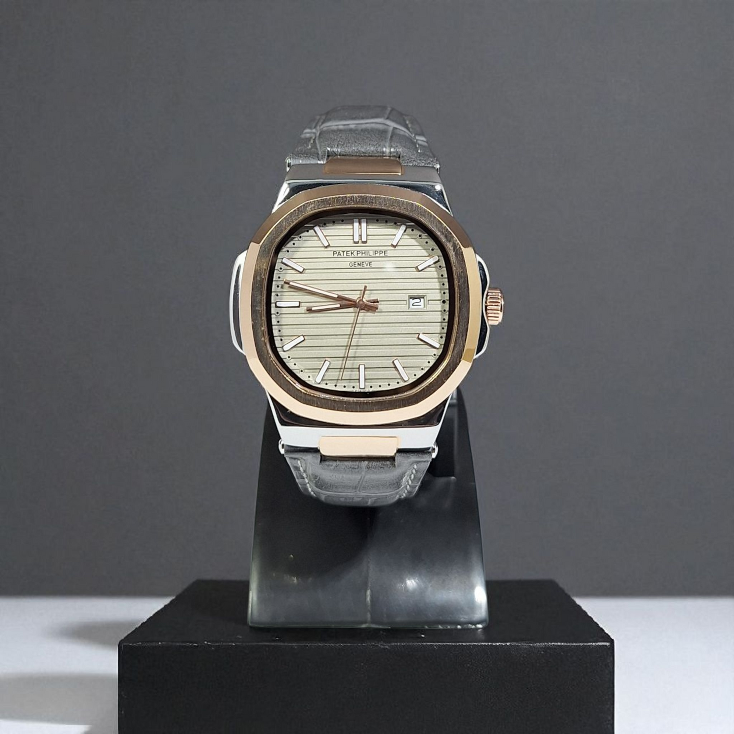 Watch on a black stand against a gray background