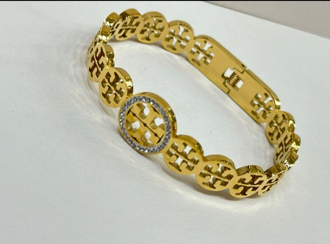 Elegant Gold and Crystal Jewelry Set with Iconic Logo Design