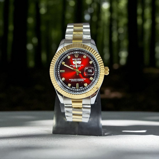 Two-tone Rolex watch with red face on a stand against a blurred natural background