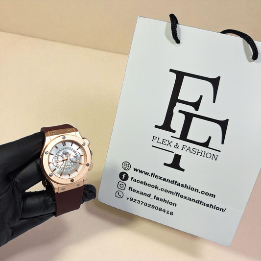 Rose gold watch held by a gloved hand next to a Flex & Fashion branded tag on a beige background